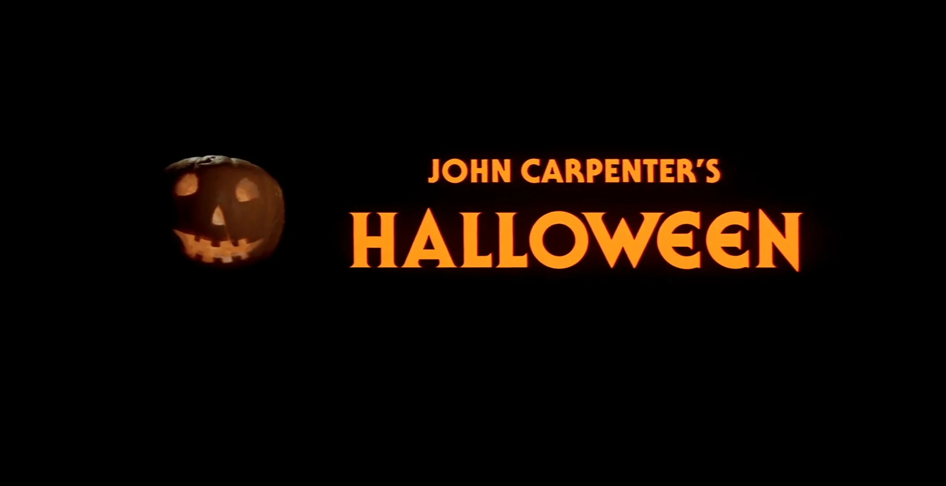 Title card for the movie: a glowing jack o lantern next to the text "John Carpenter's Halloween"