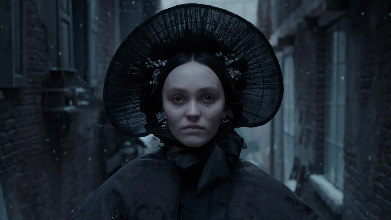 Still from Nosferatu: Ellen (Lily Rose Depp) walks in the snow through an alley