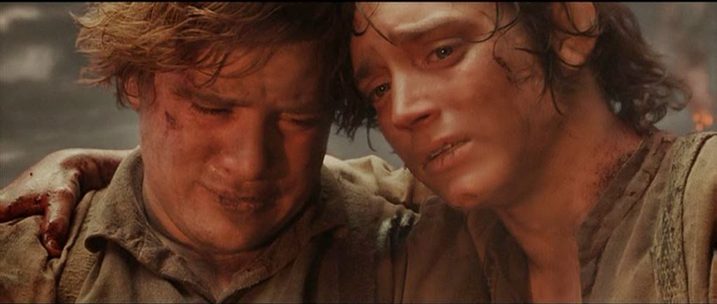Frodo and Sam embrace each other on a volcanic mountainside