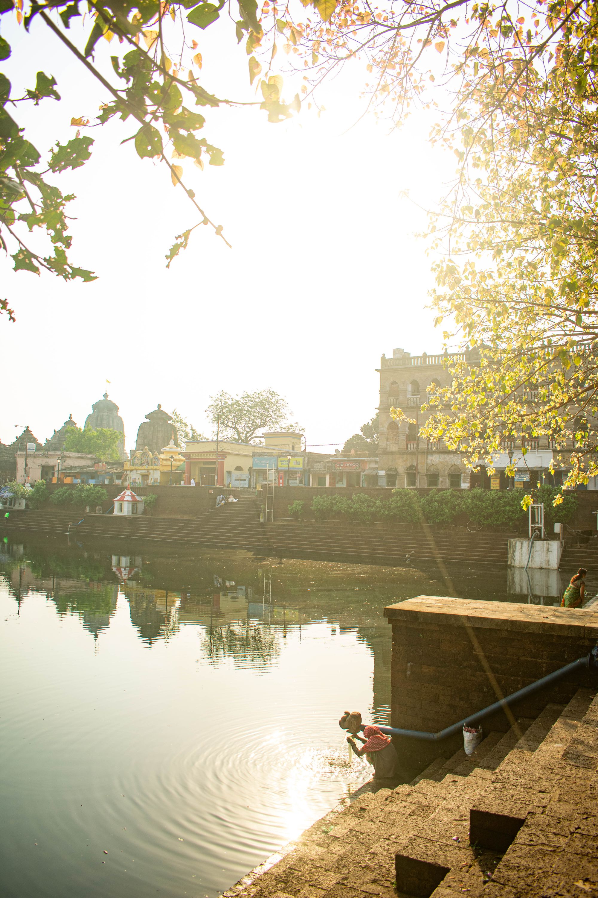 Lady washing clothes in the Lake in the morning