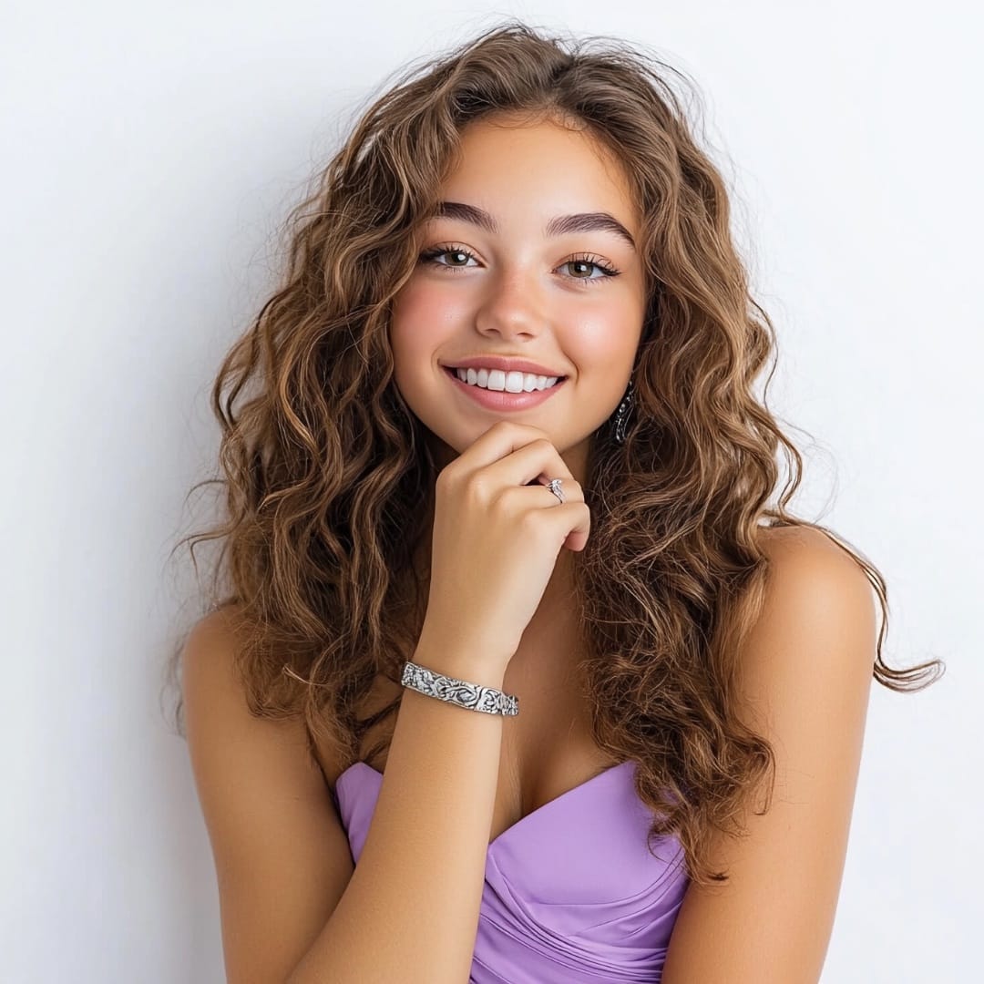 Woman with curly brown hair and a purple dress